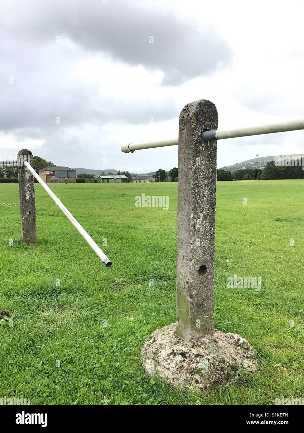 Broken section of a crowd control barrier around a playing field and sports pitch - Smartphone Captured Stock Image