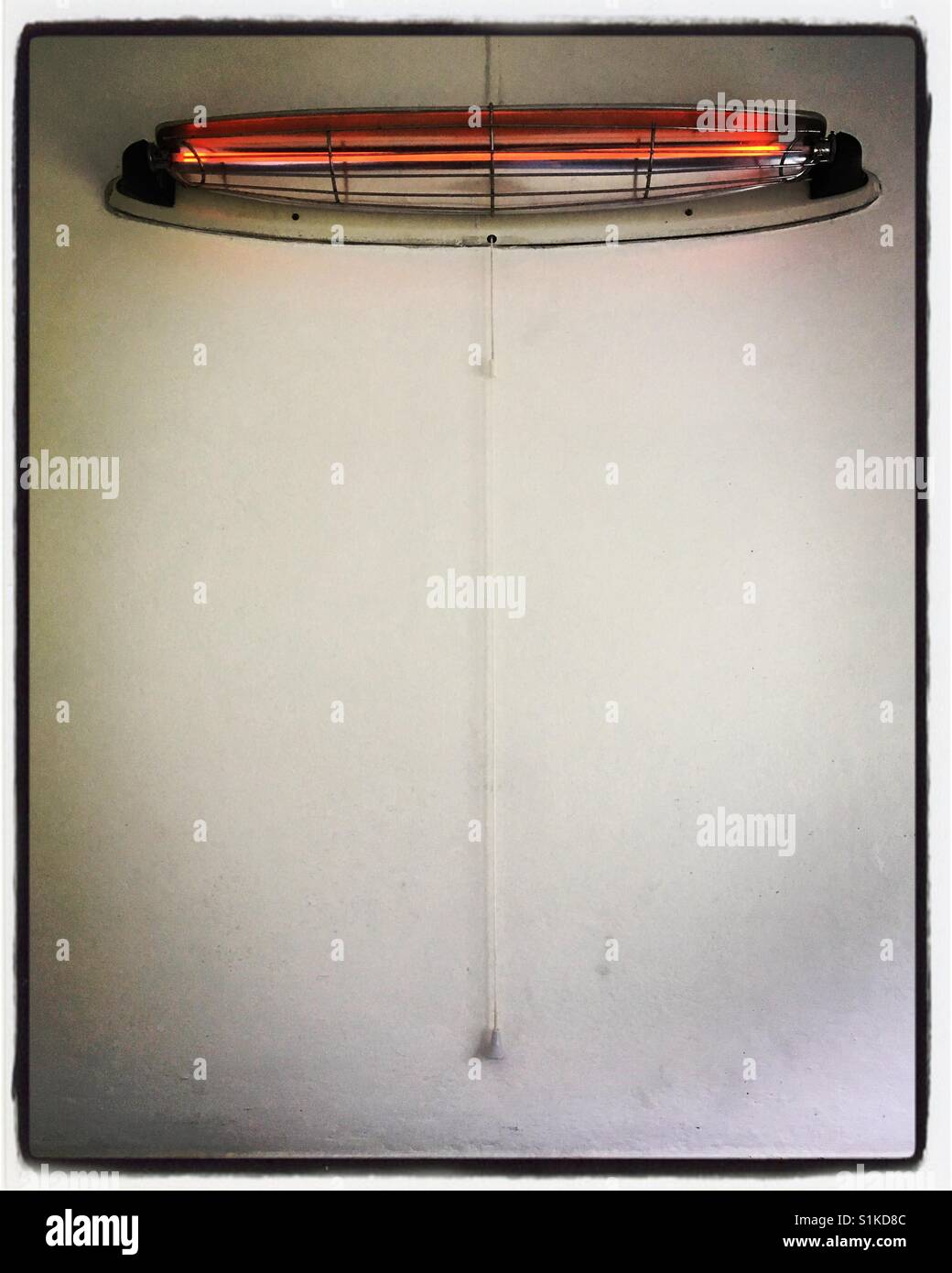 Old fashioned wall mounted bathroom heater Stock Photo - Alamy