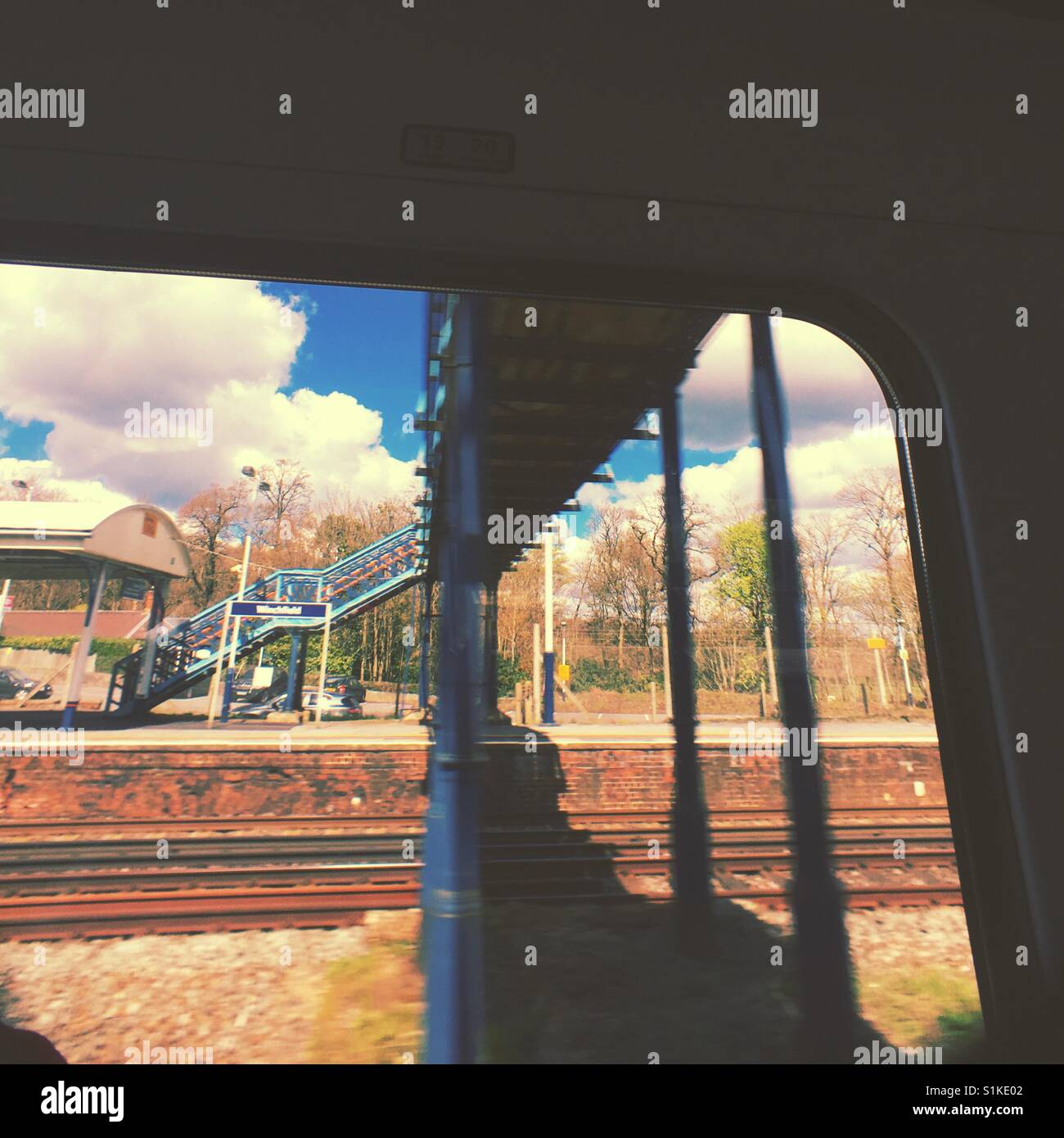 View from train window blue sky rail station - Smartphone Captured Stock Image