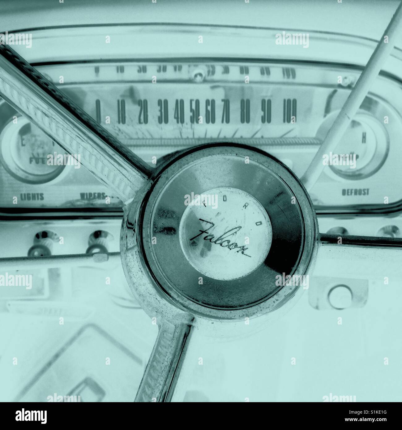 Closeup interior view of vintage Ford Falcon  dashboard and steering wheel Aqua filtered - Smartphone Captured Stock Image