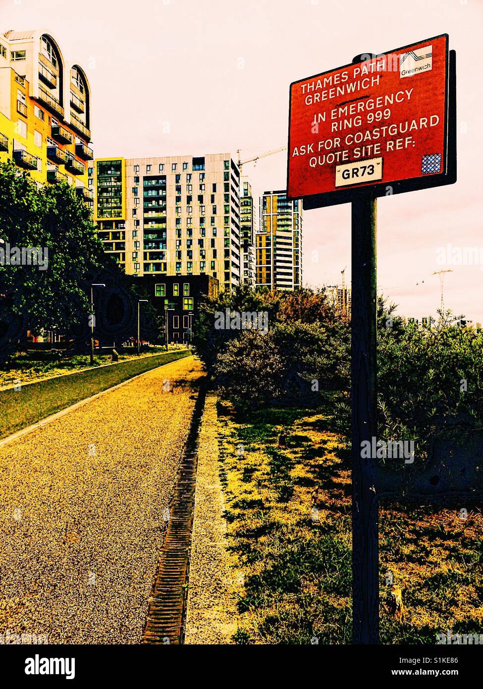 Red emergency information sign on Thames Path, Greenwich Peninsula, London, England - Smartphone Captured Stock Image
