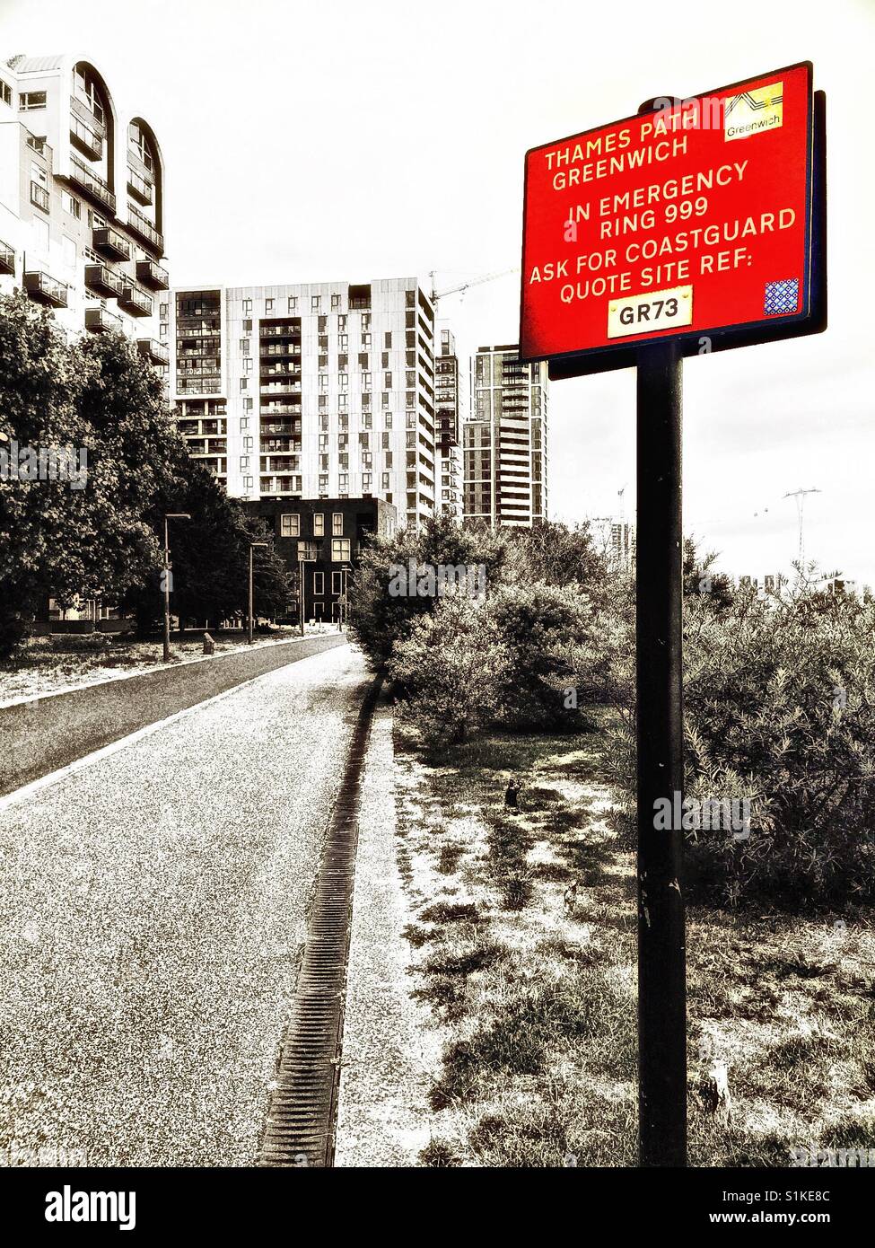 Red emergency information sign on Thames Path, Greenwich Peninsula, London, England - Smartphone Captured Stock Image