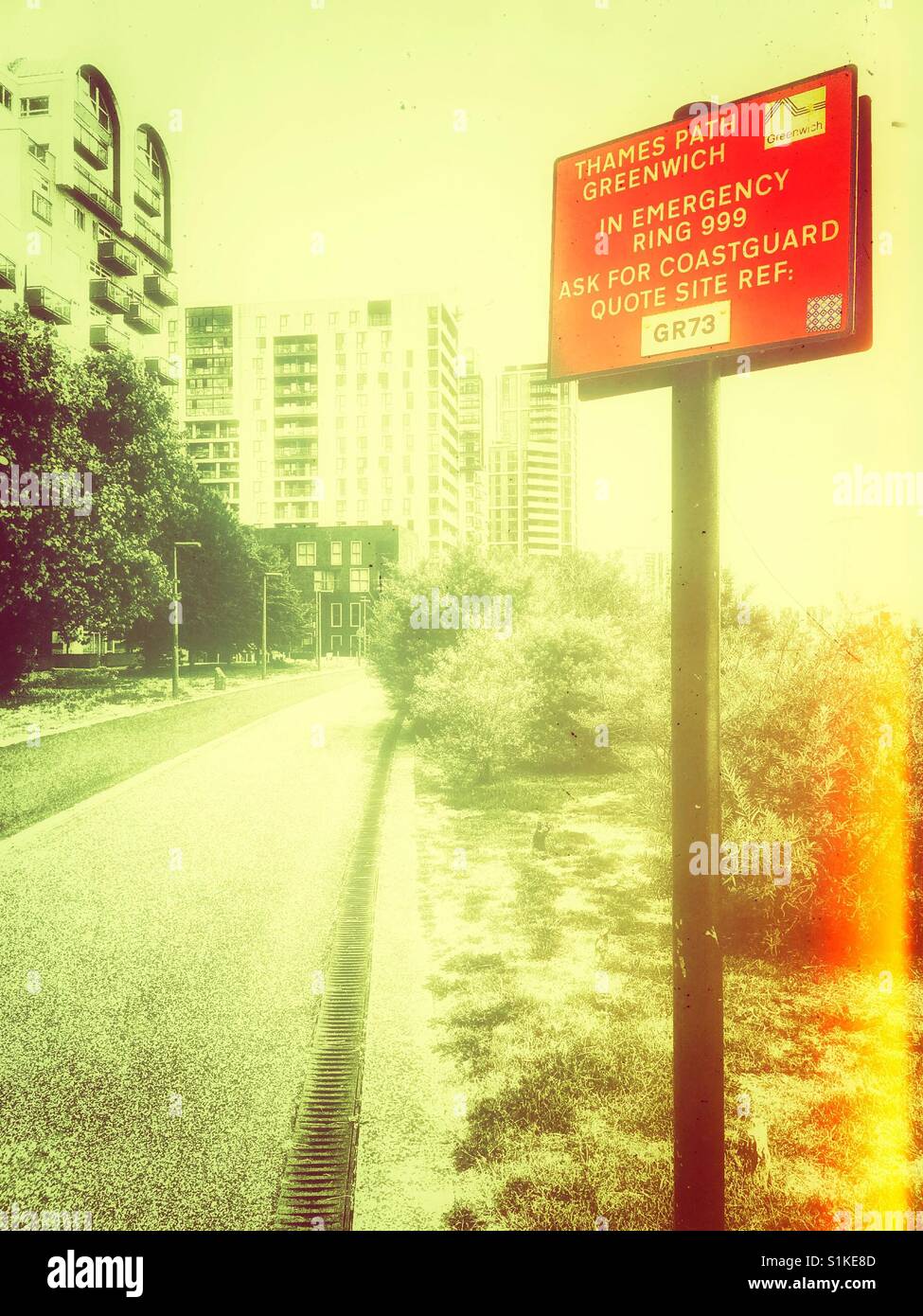 Red emergency information sign on Thames Path, Greenwich Peninsula, London, England - Smartphone Captured Stock Image