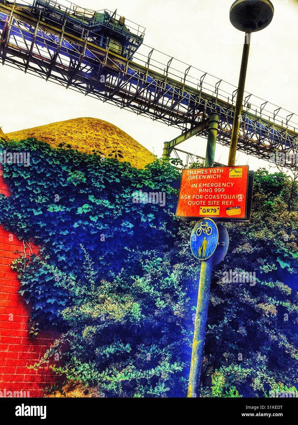 Quarry transportation system and red emergency information sign, Thames path, Greenwich Peninsula, London, England - Smartphone Captured Stock Image