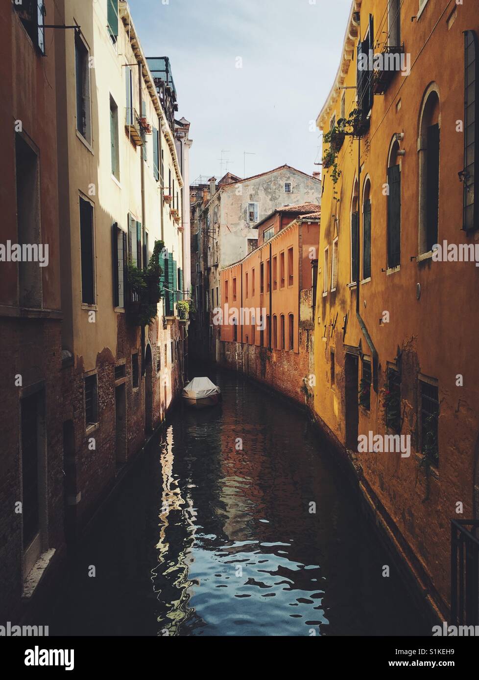 Boat parked in one of the side canals in Venice, Italy Stock Photo
