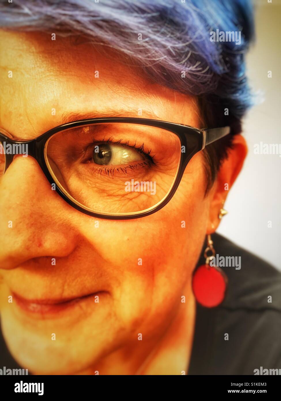 Middle aged woman with blue dyed hair - Smartphone Captured Stock Image