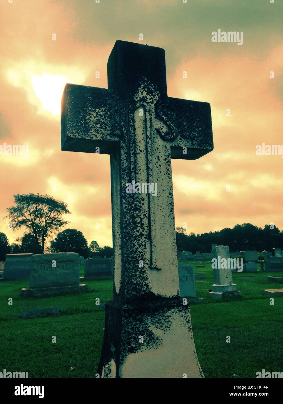 In His Service- moss covered monument cross in North Carolina cemetery - Smartphone Captured Stock Image