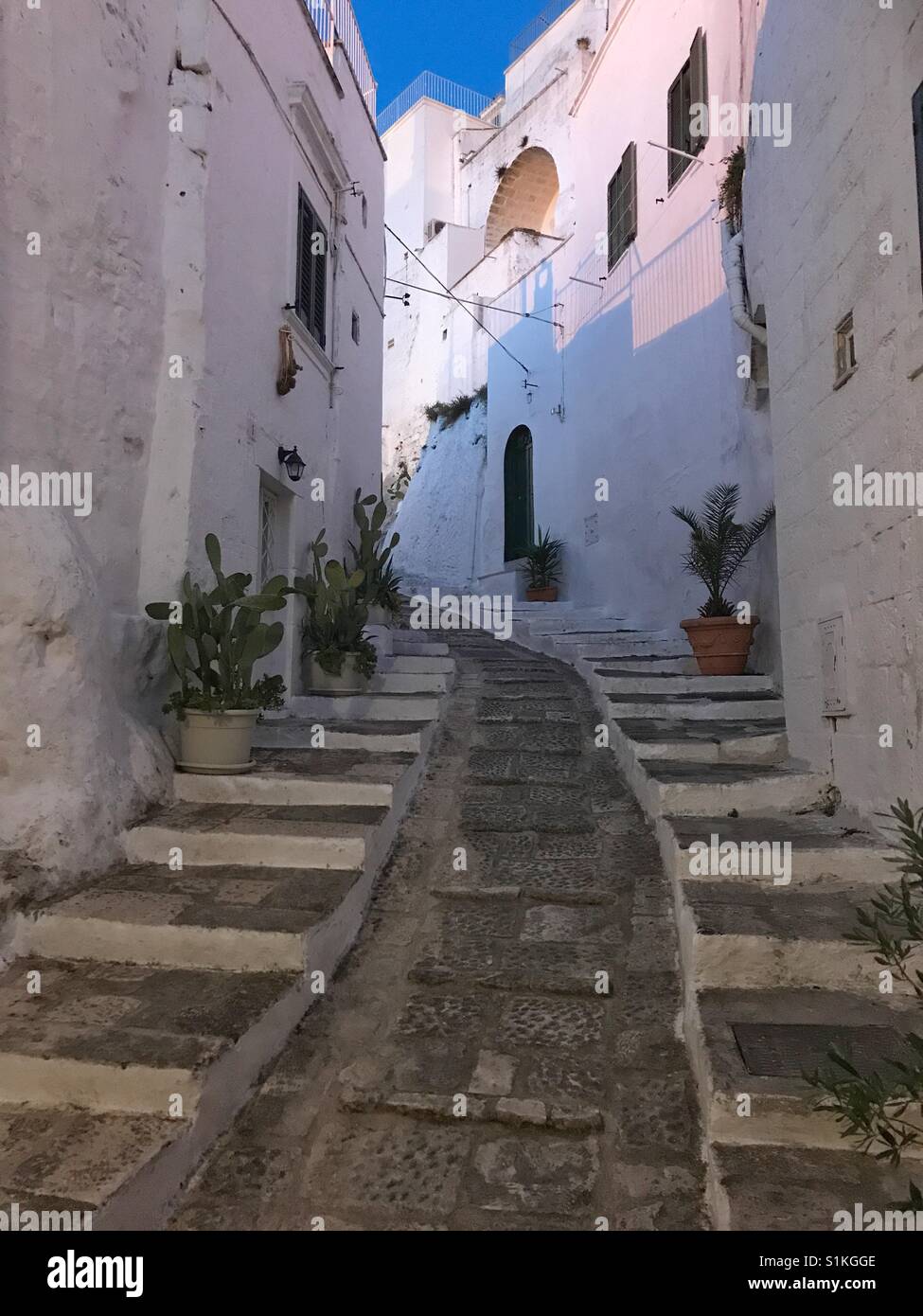 Typical romantic narrow street in the famous white city of Ostuni, Puglia, Italy Stock Photo