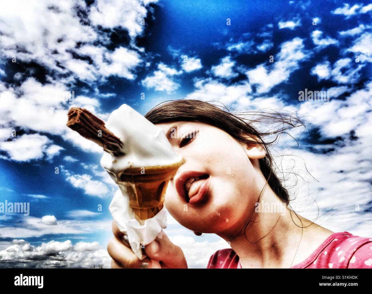 Girl eating ice cream on a hot day - Smartphone Captured Stock Image