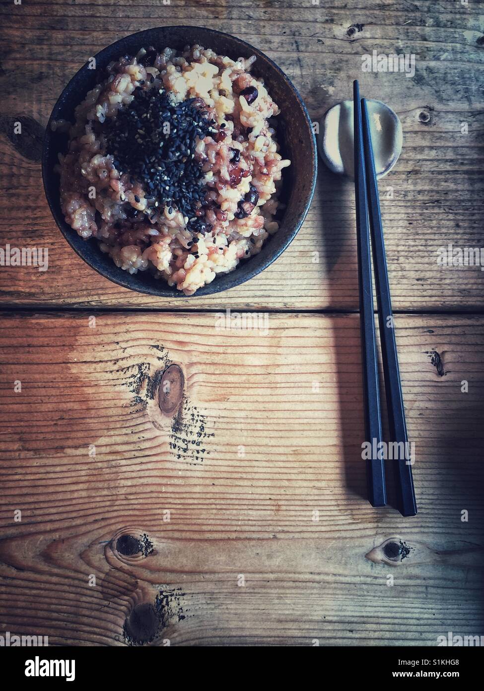 Traditional Kyoto style red rice in a bowl with chopsticks and  black sesame seeds - Smartphone Captured Stock Image
