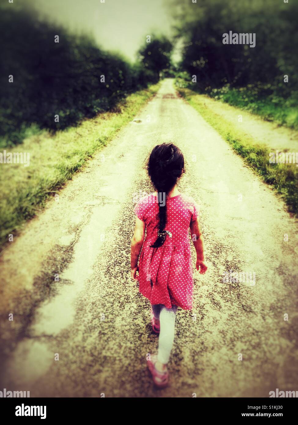 Child walking along a county lane in England. - Smartphone Captured Stock Image