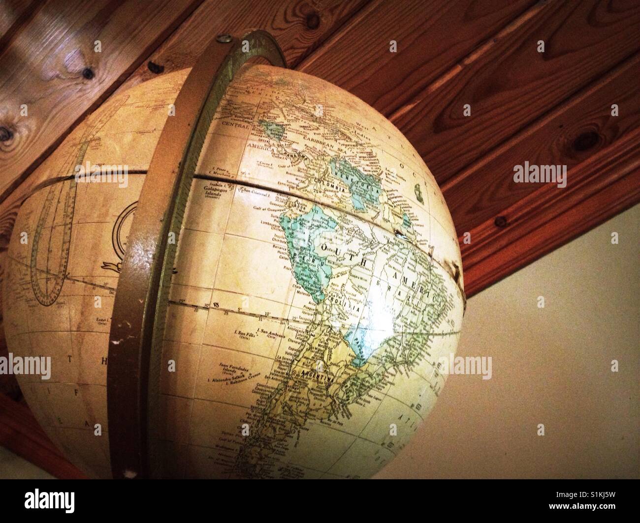 Vintage globe with wood ceiling background - Smartphone Captured Stock Image