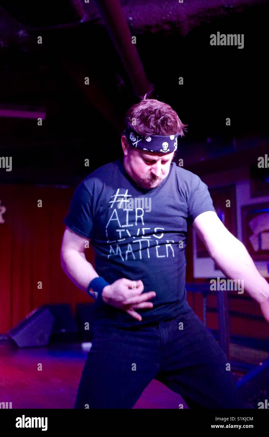 Man plays air guitar wearing air lives matter Tshirt - Smartphone Captured Stock Image