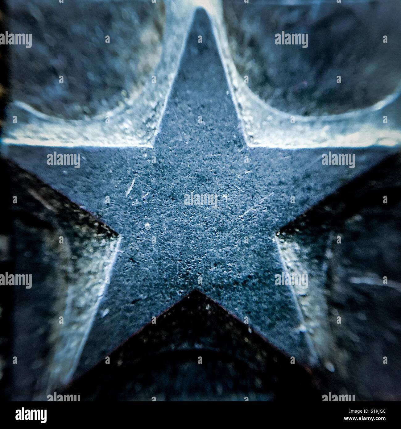 Grungy old metal printers block star stamp Stock Photo Alamy