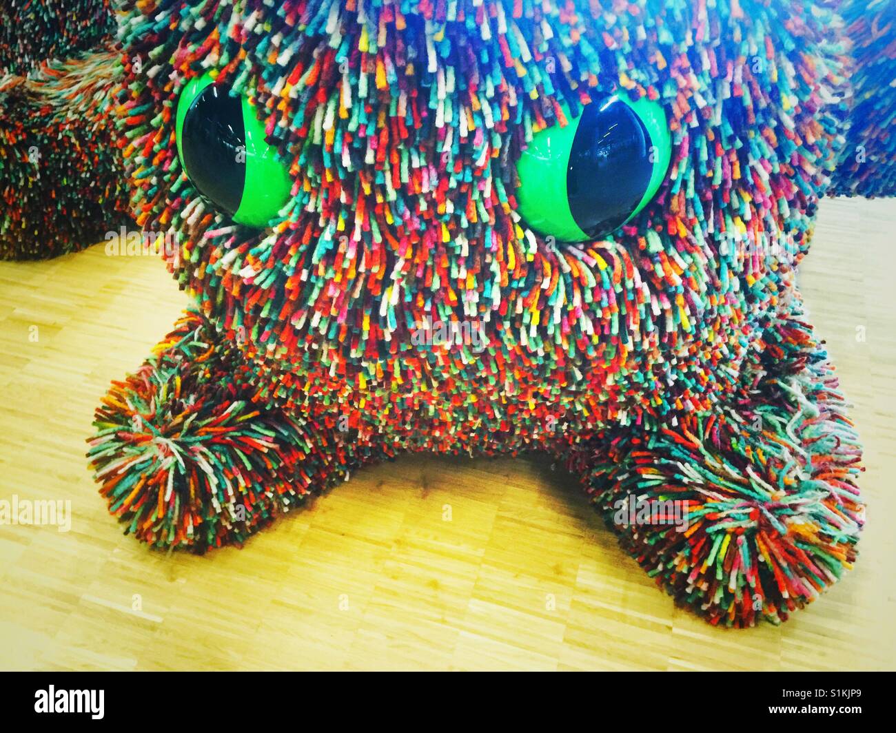 Giant fluffy weird climbing monster at Schilpol international airport in Amsterdam - Smartphone Captured Stock Image