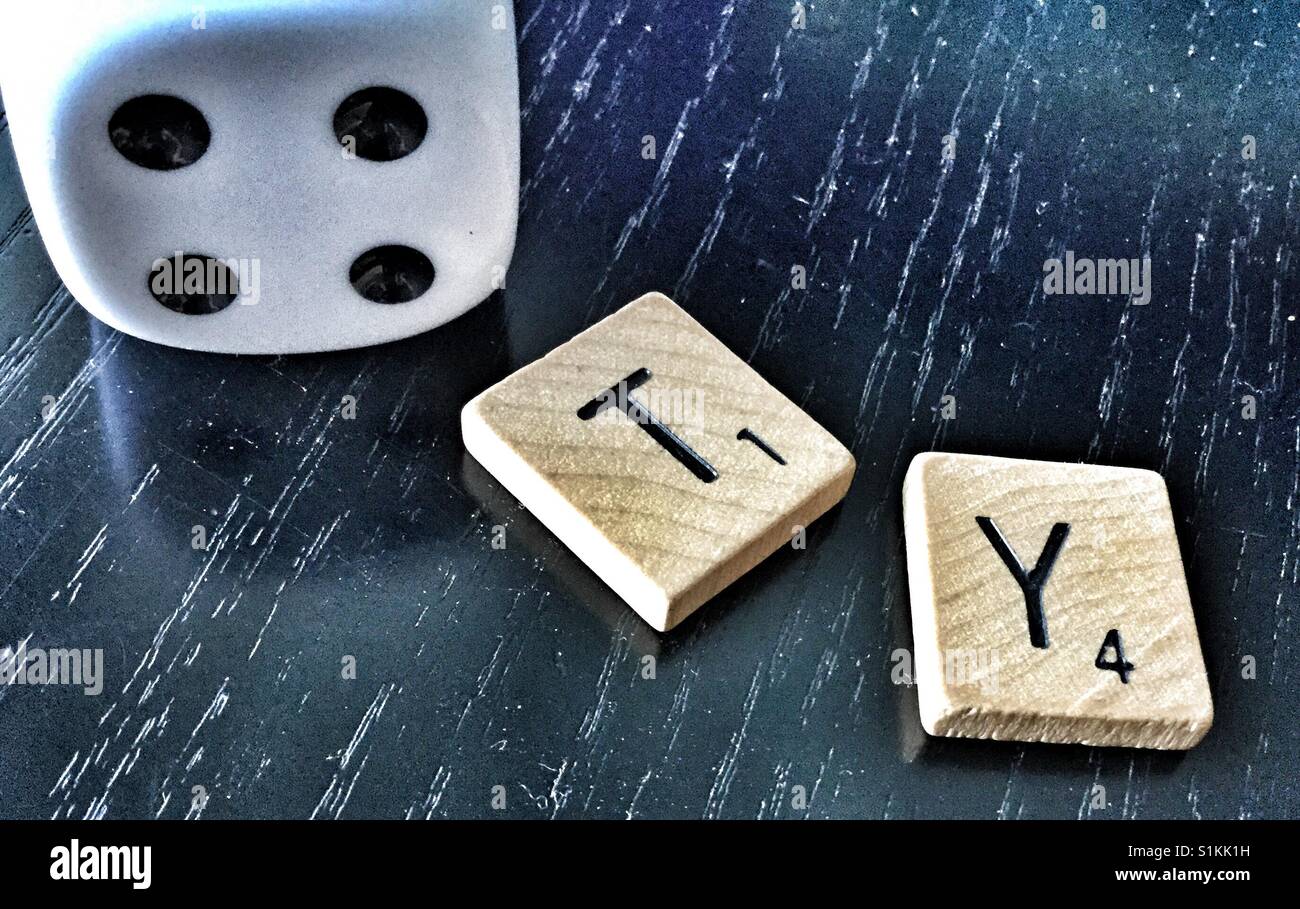 White dice and scrabble letters. Stock Photo