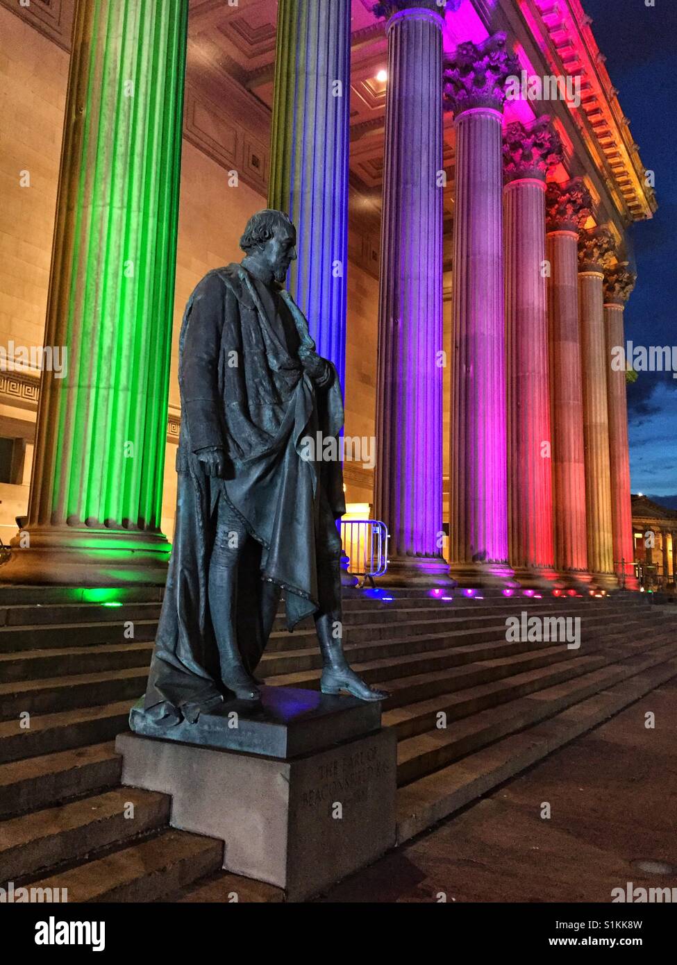 Statue of the Earl of Beaconsfield outside St George's Hall, Liverpool with colours for gay pride march showing Stock Photo