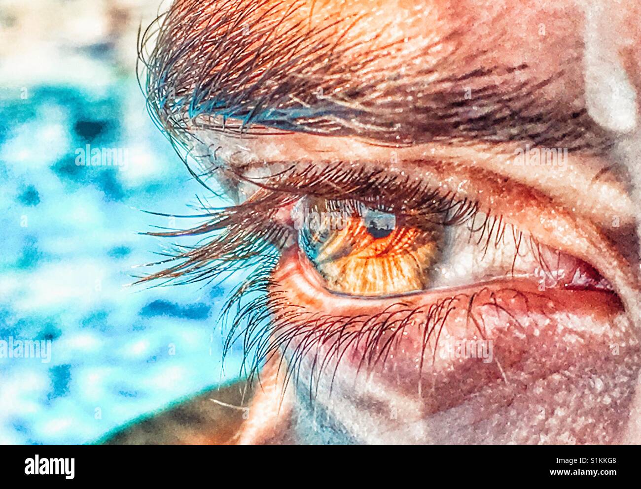 Human eye, young woman in a swimming pool - Smartphone Captured Stock Image