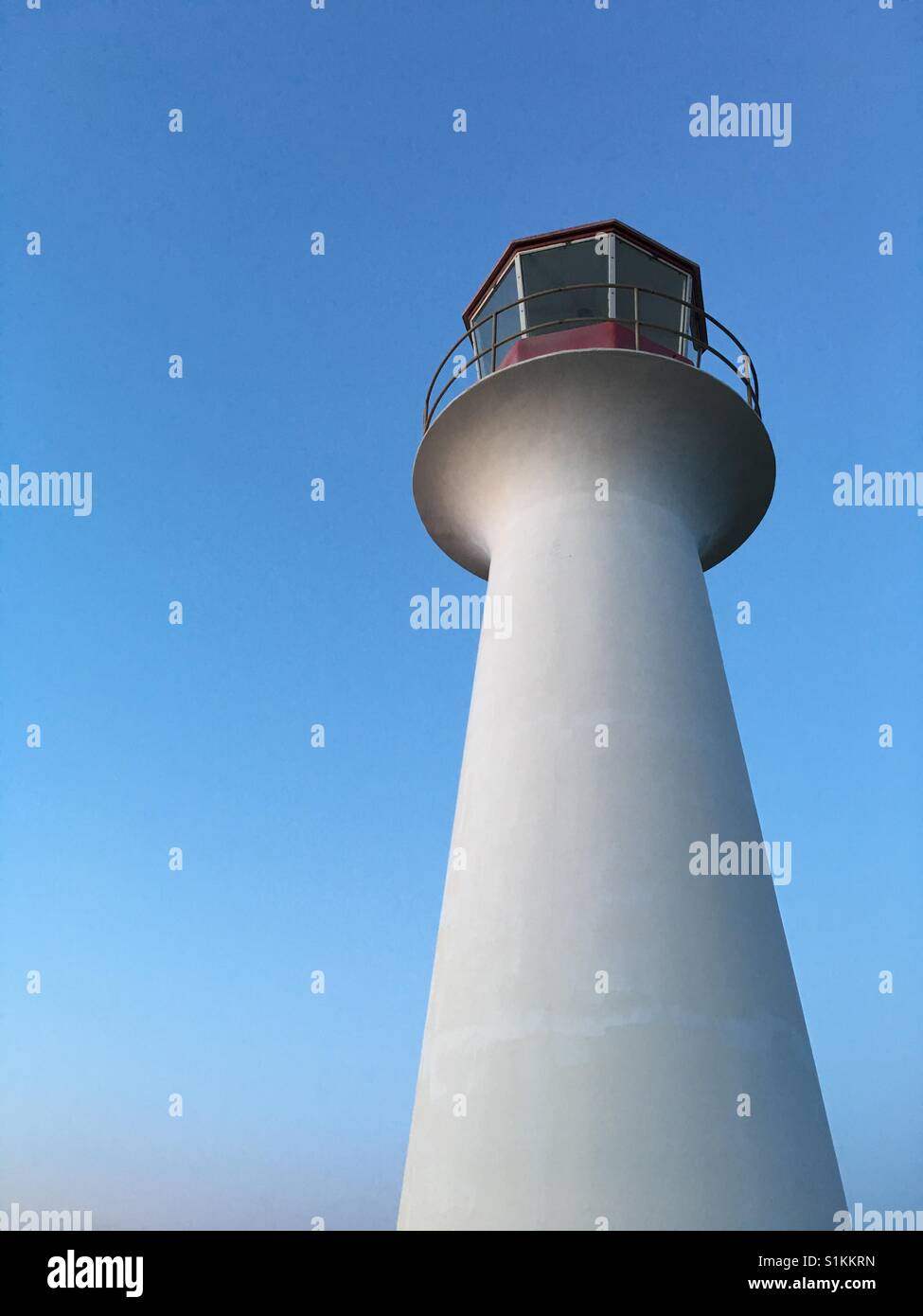 White lighthouse at sunset Stock Photo