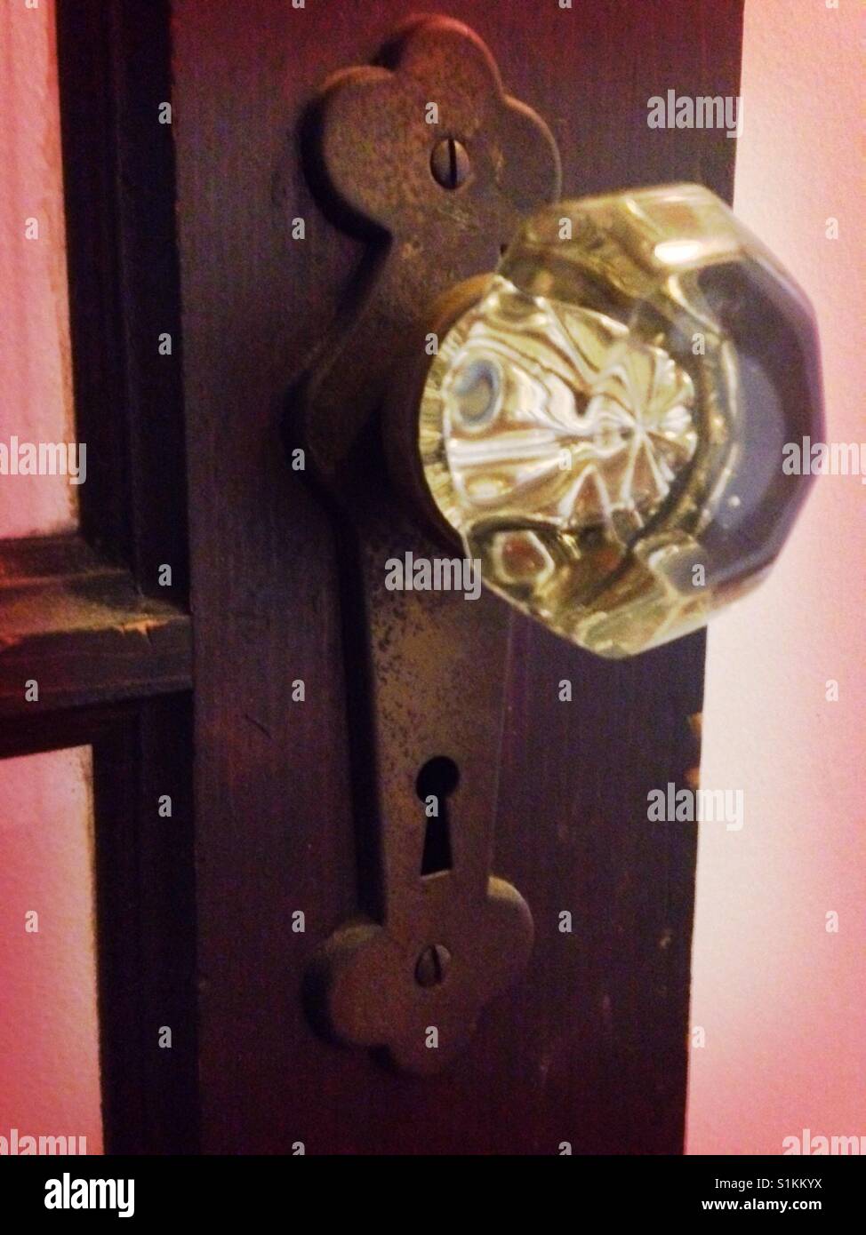 Glass doorknob, wooden door Stock Photo