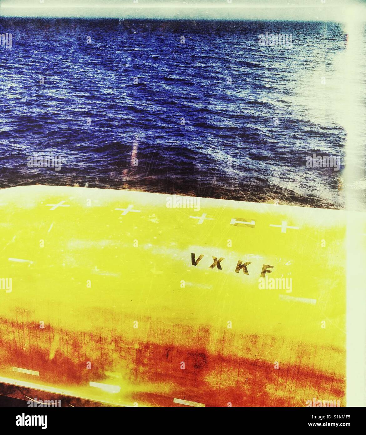 Underside of orange lifeboat and ocean - Smartphone Captured Stock Image