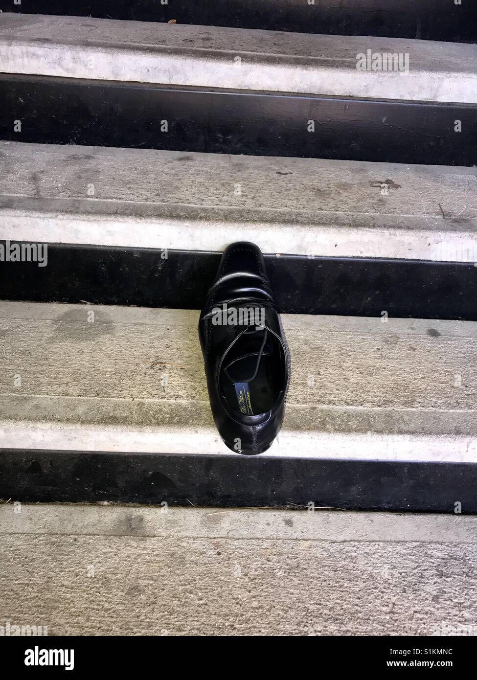 Lost dress shoe on stairs Stock Photo