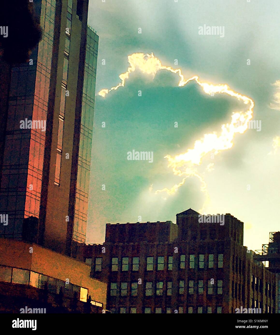 Backlit cloud and New York City skyscrapers , NYC, USA Stock Photo