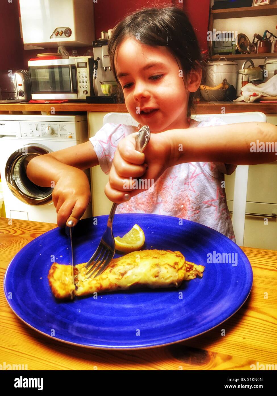 Girl eating a pancake hires stock photography and images Alamy