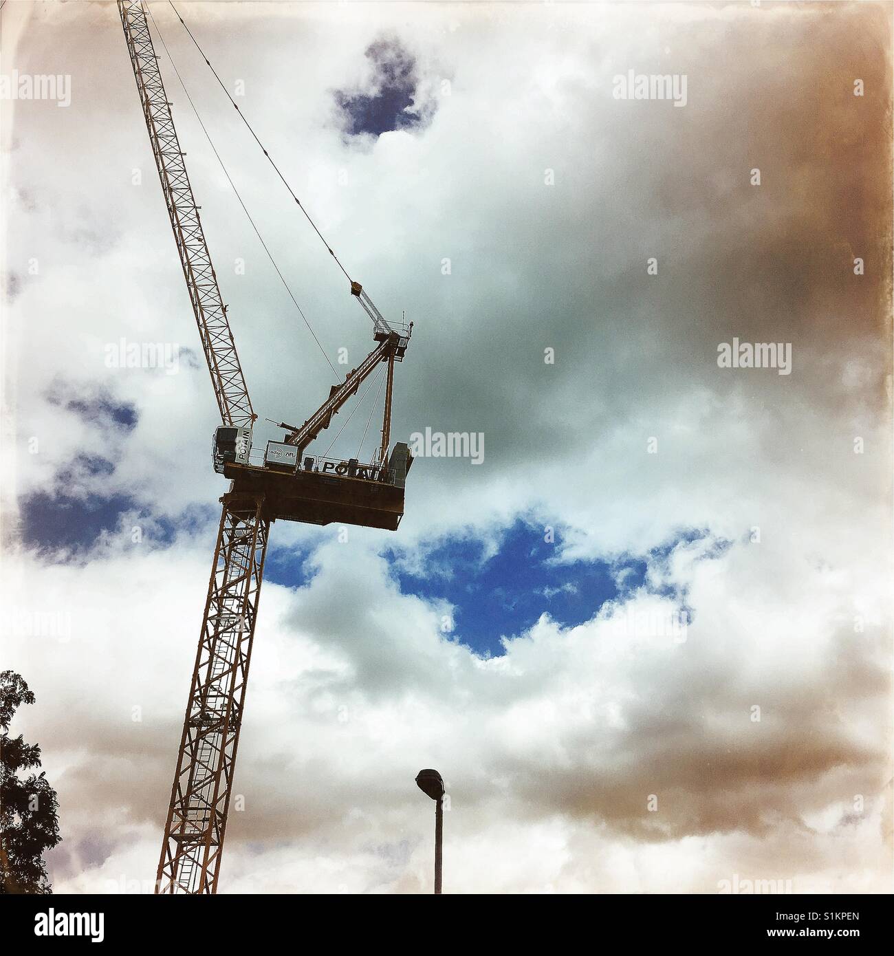 Crane against a cloudy sky Stock Photo - Alamy