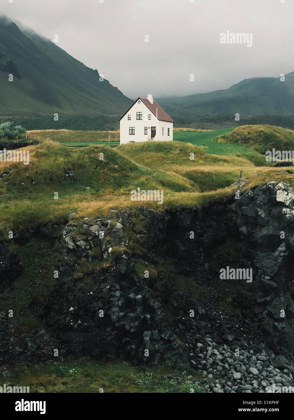 White House, green hills, grey skies. - Smartphone Captured Stock Image