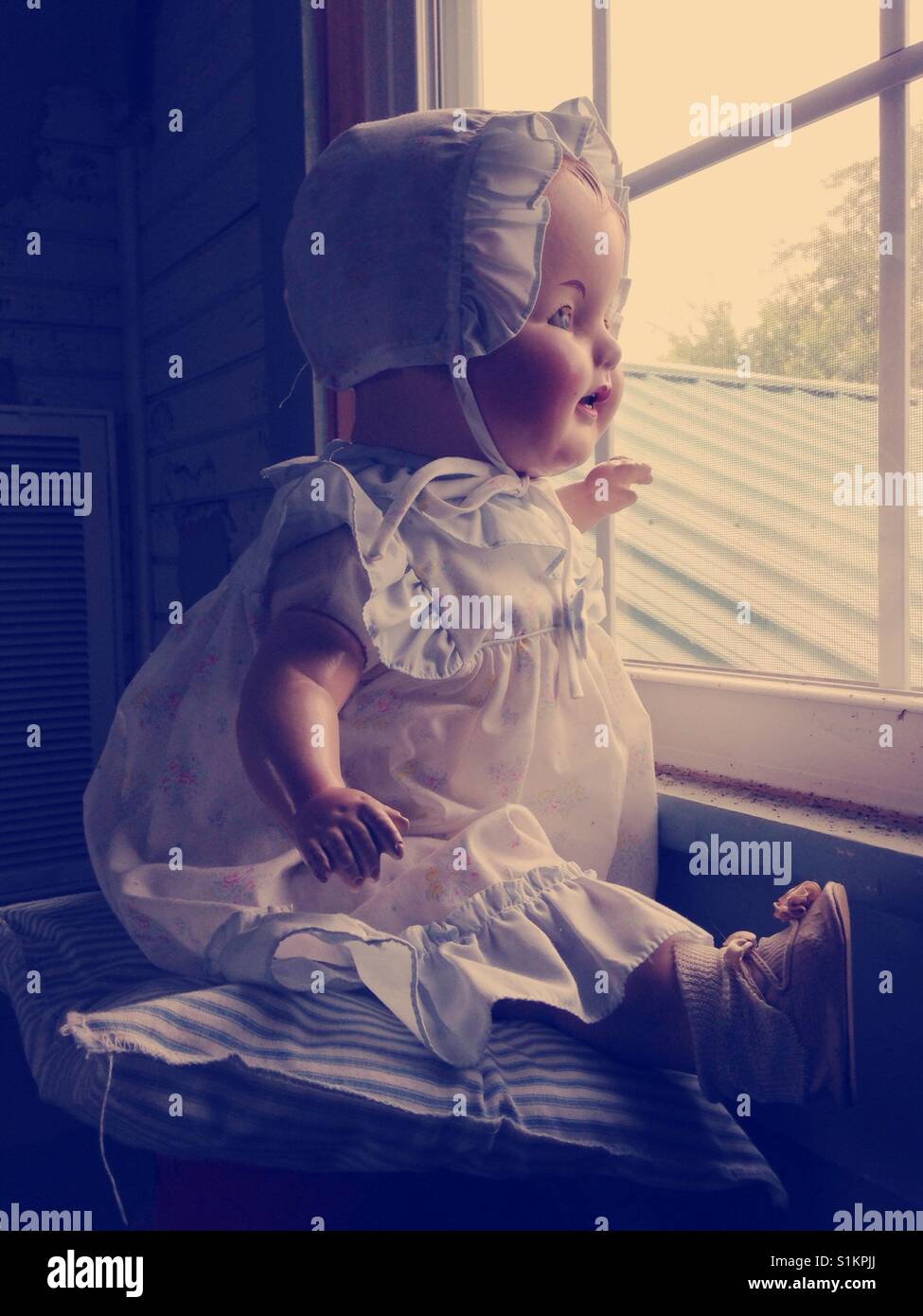 Daddy watch- Doris the composition doll waits for Daddy - Smartphone Captured Stock Image