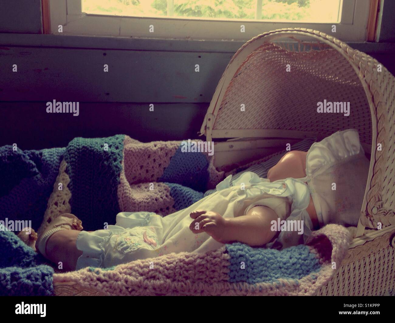 Don't wake the baby! - Doris the composition doll wearing ruffles bonnet and dress naps in vintage bassinet - Smartphone Captured Stock Image