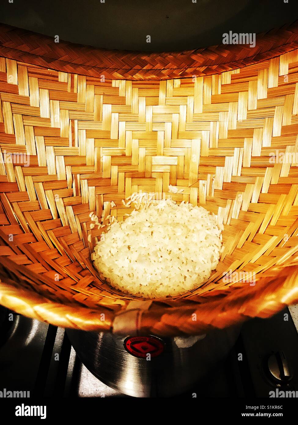 Cooking sticky rice in bamboo basket Stock Photo