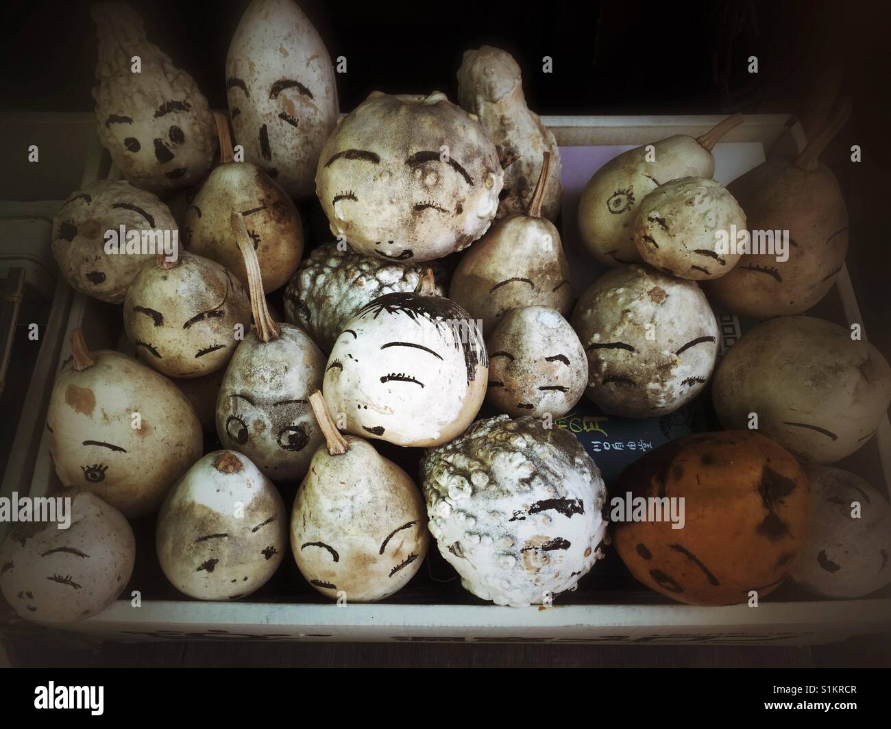 Funny small white gourds decorated with hand drawn faces in Kyoto Stock Photo