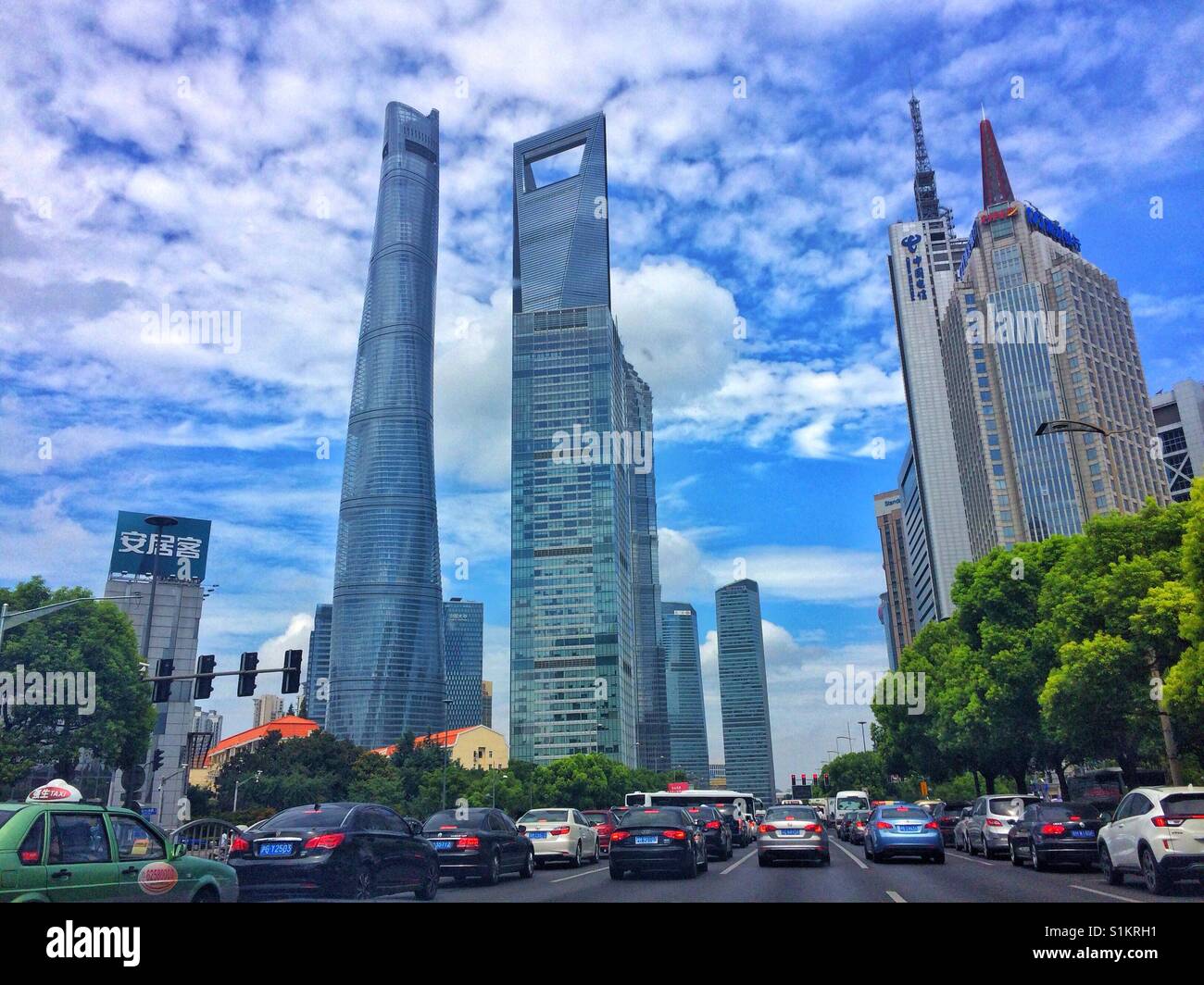 Travelling up the road towards skyscrapers in Shanghai. Stock Photo