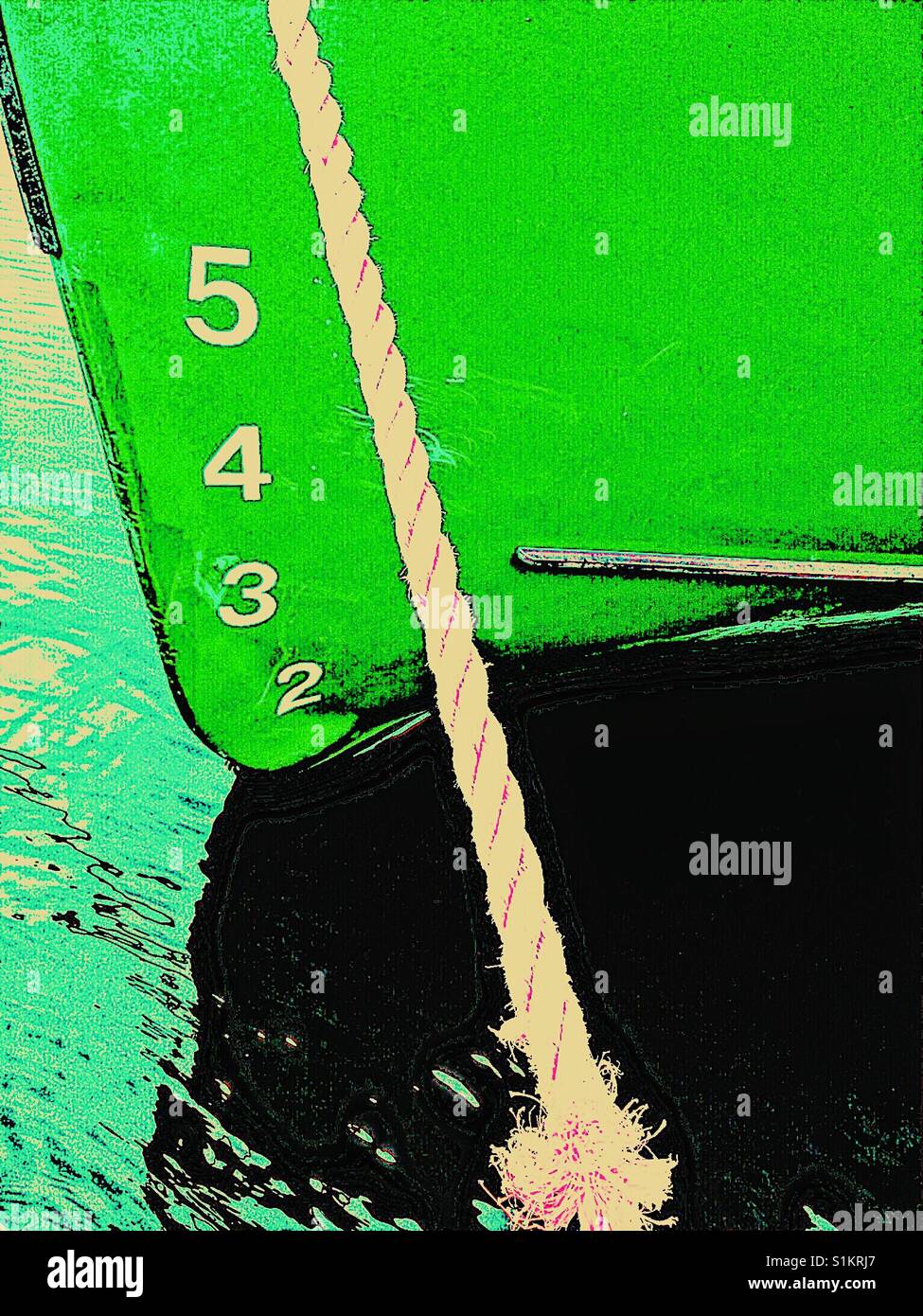 Ship's draft on green hull of moored ship. The vertical distance between the waterline and the bottom of the hull. - Smartphone Captured Stock Image