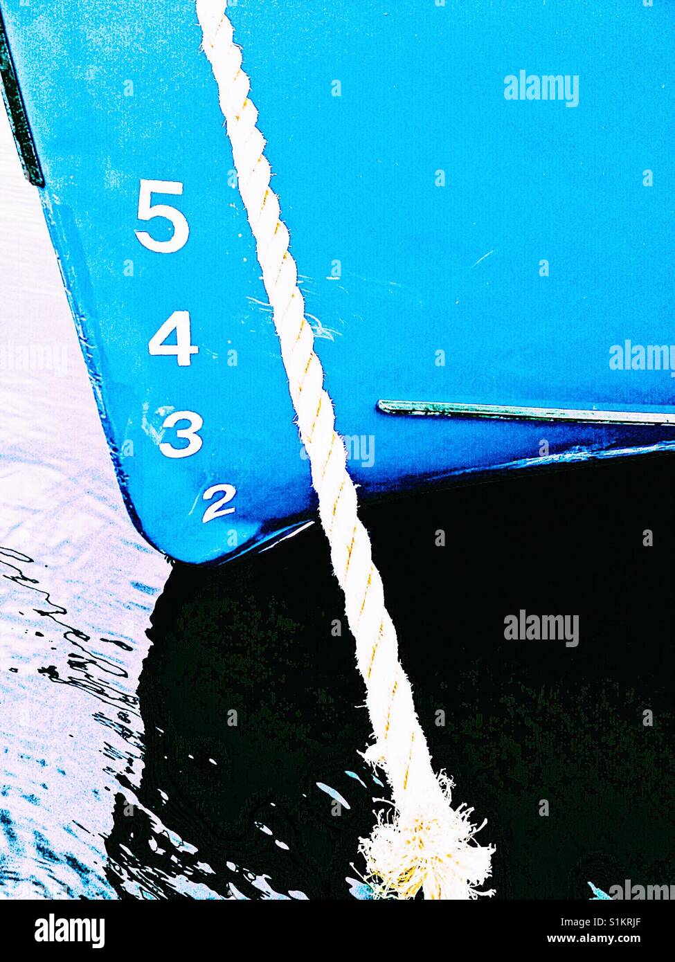 Ship draft on blue hull of moored boat. The vertical distance between the waterline and the bottom of the hull. - Smartphone Captured Stock Image