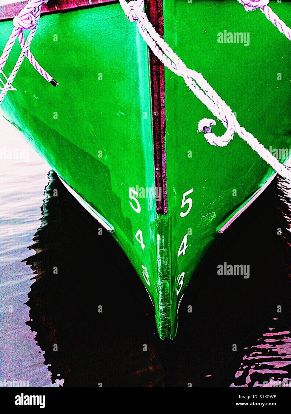 Ship's draft on green hull of moored ship. The vertical distance between the waterline and the bottom of the hull. - Smartphone Captured Stock Image