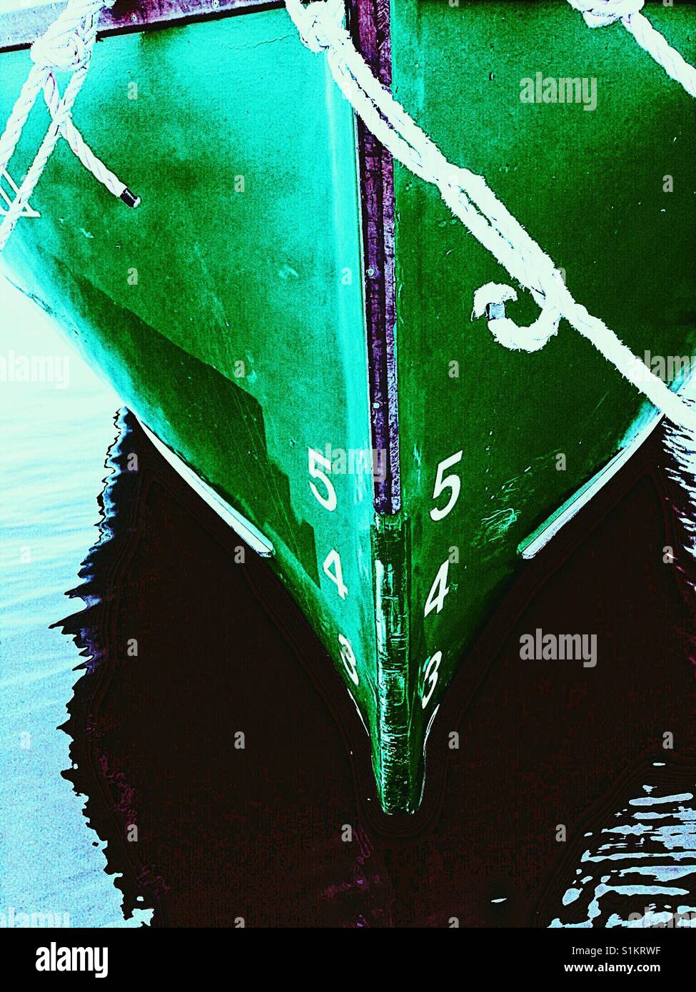 Ship's draft on green hull of moored ship. The vertical distance between the waterline and the bottom f the hull. - Smartphone Captured Stock Image
