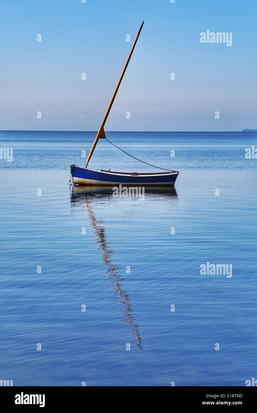 A boat mirrored in water Stock Photo