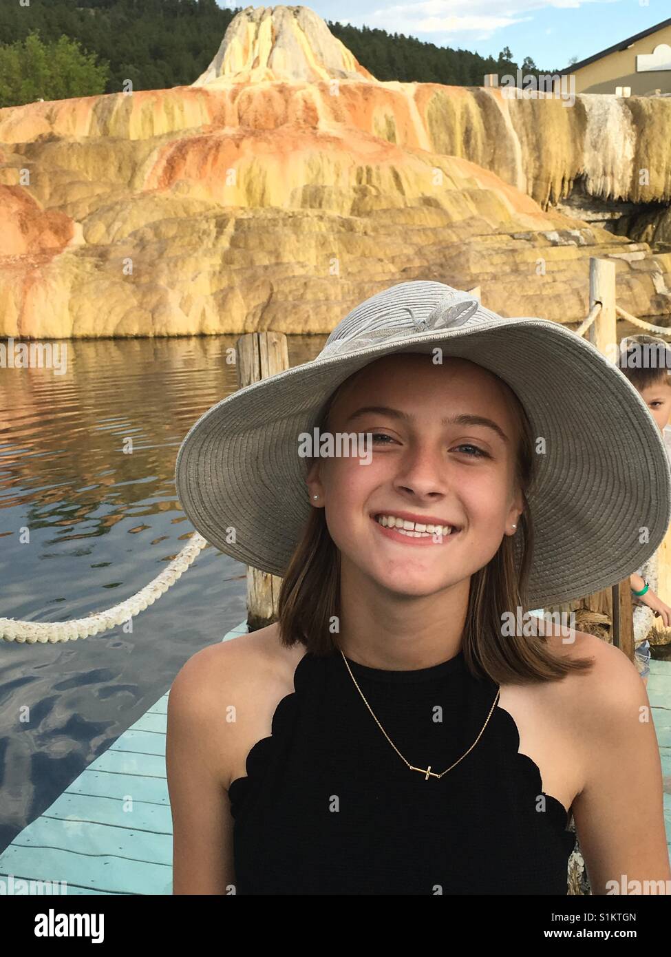 Young Girl in Big Hat Enjoying Summer Hot Springs Stock Photo