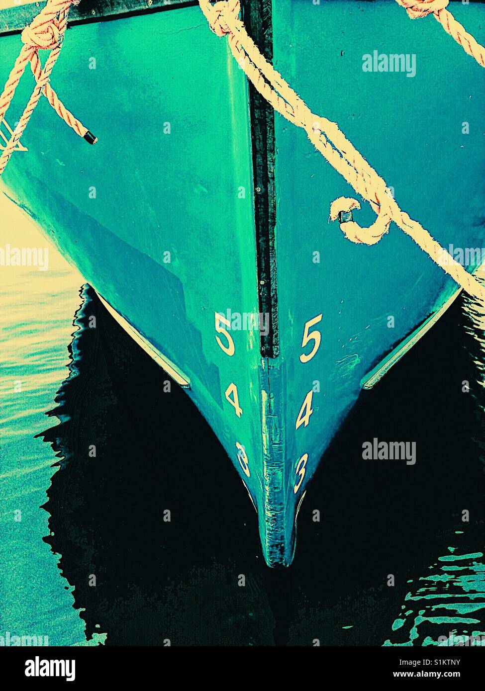 Ship's draft on blue hull of moored ship. The vertical distance between the waterline and the bottom of the hull. - Smartphone Captured Stock Image