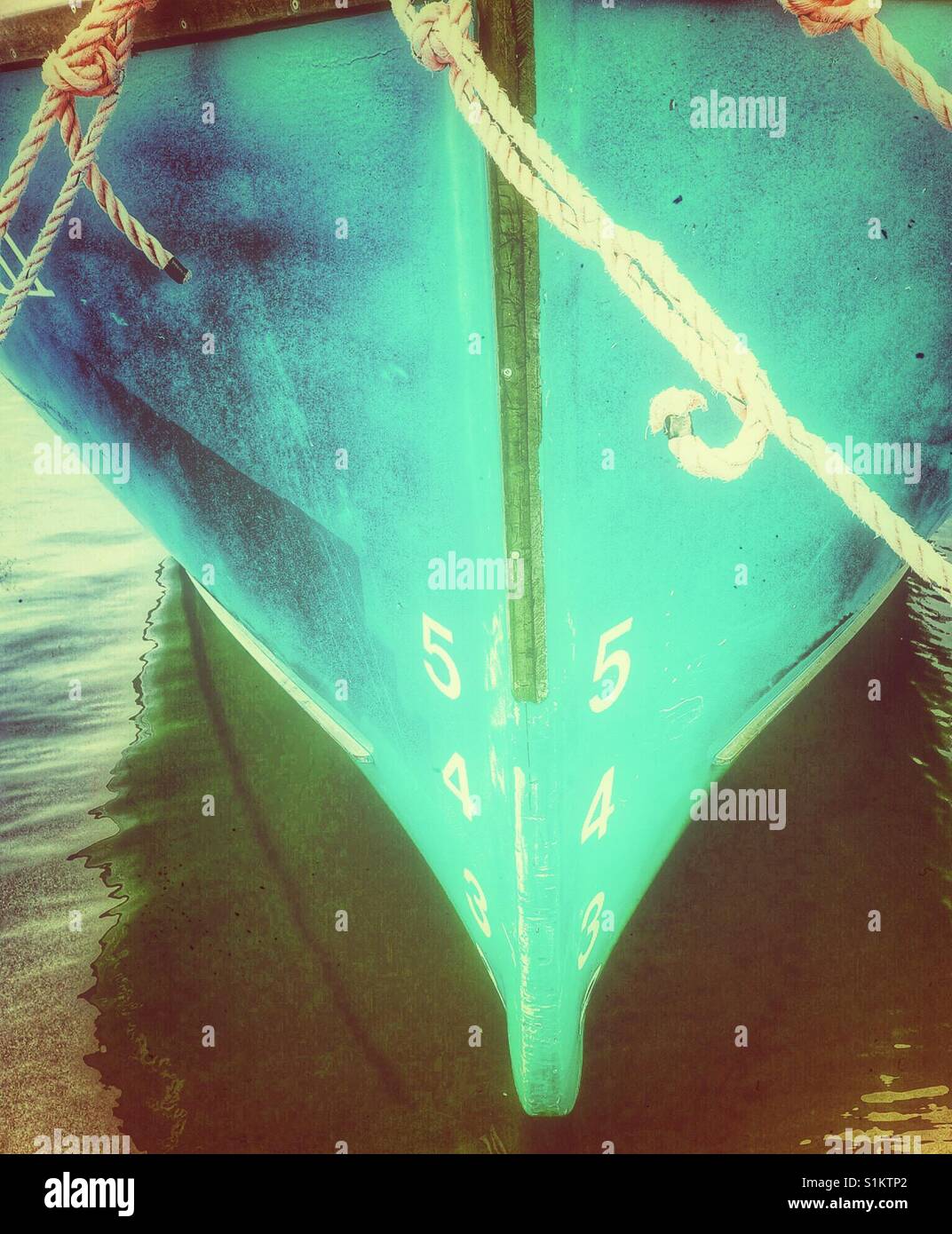 Ship's draft on blue hull of moored ship. The vertical distance between the waterline and  the bottom of the hull. - Smartphone Captured Stock Image