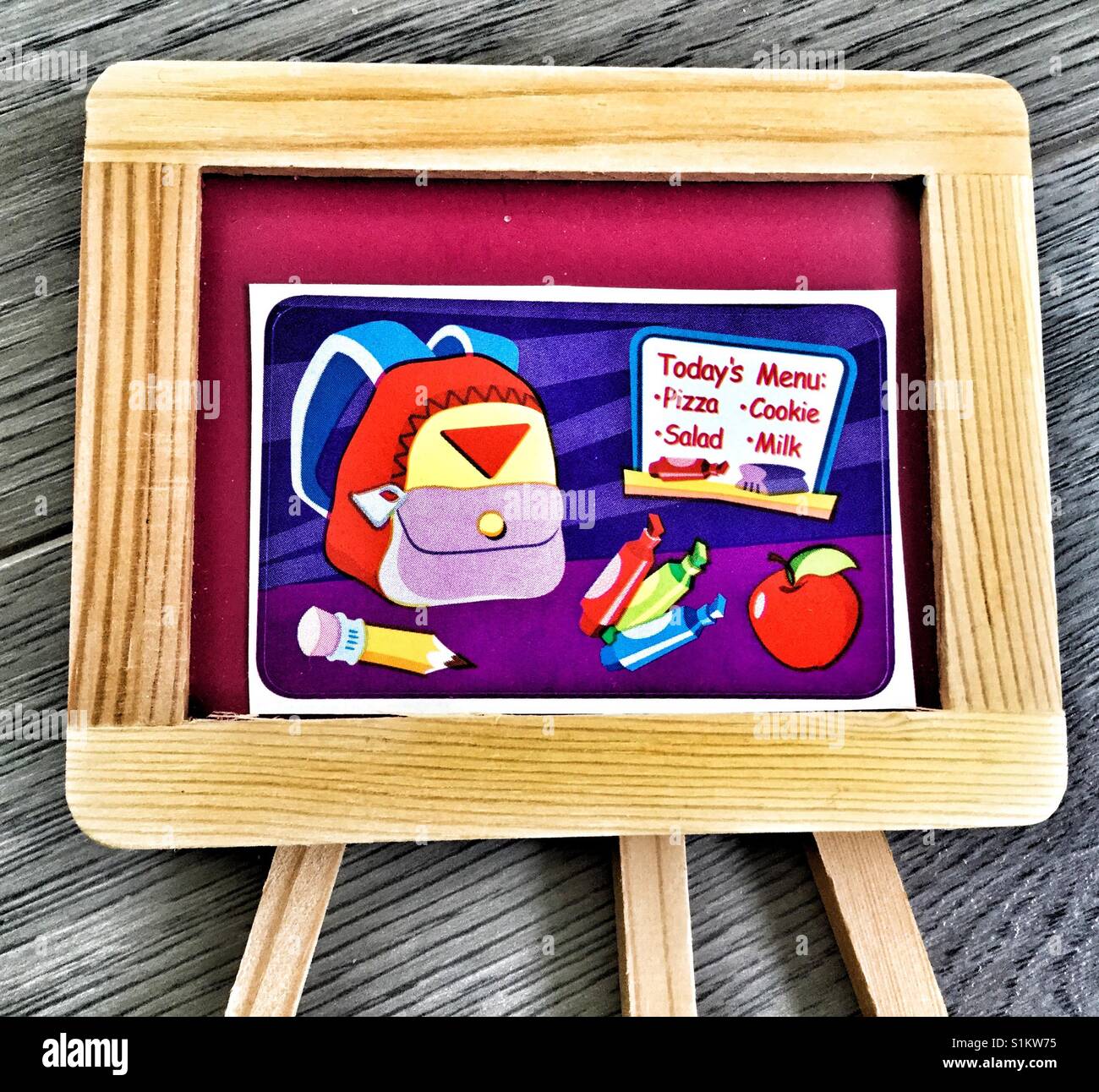 Miniature chalkboard with image of backpack and contents. - Smartphone Captured Stock Image