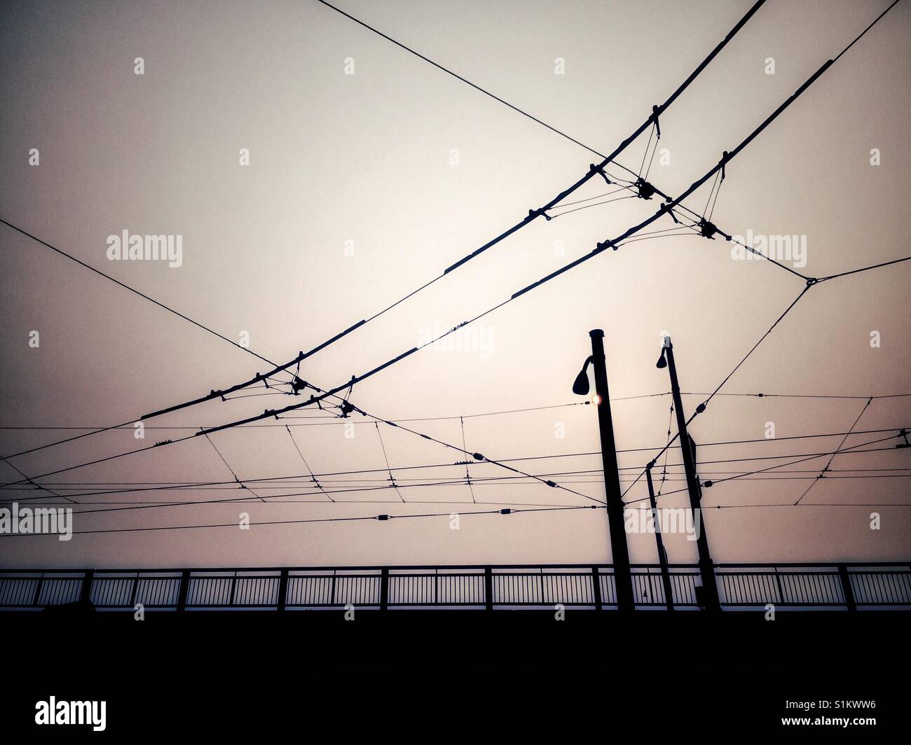 Street lamps and electric trolley lines on a hot and hazy morning. Granville Street bridge, Vancouver, Canada. - Smartphone Captured Stock Image