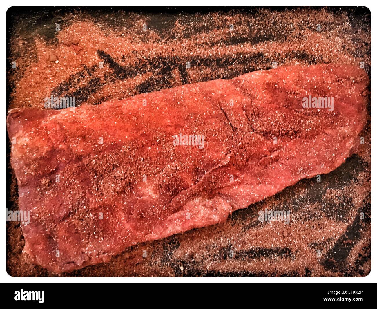 Rack of Baby Back Pork Ribs covered in dry rub and ready for the oven