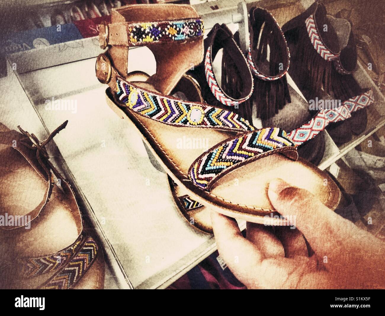 Woman looking at shoes in a Spanish shoe shop - Smartphone Captured Stock Image