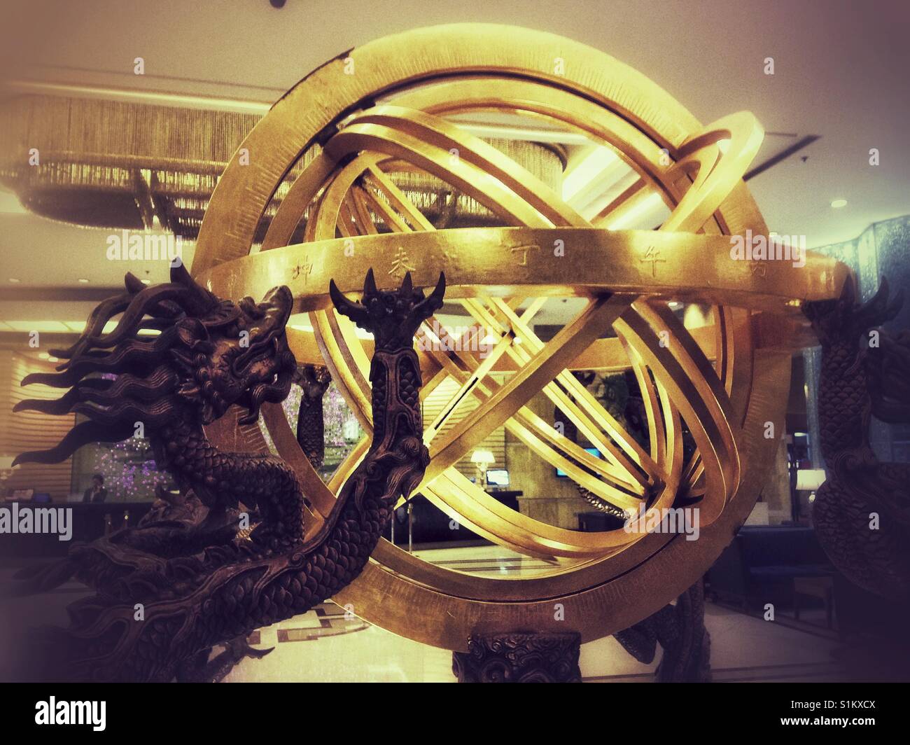 A dragon claws at an armillary sphere. - Smartphone Captured Stock Image