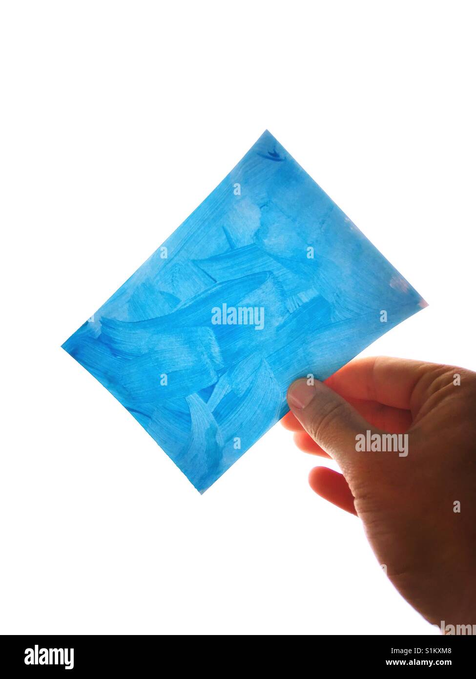 Blue Card in a Male Hand against a white background - Smartphone Captured Stock Image