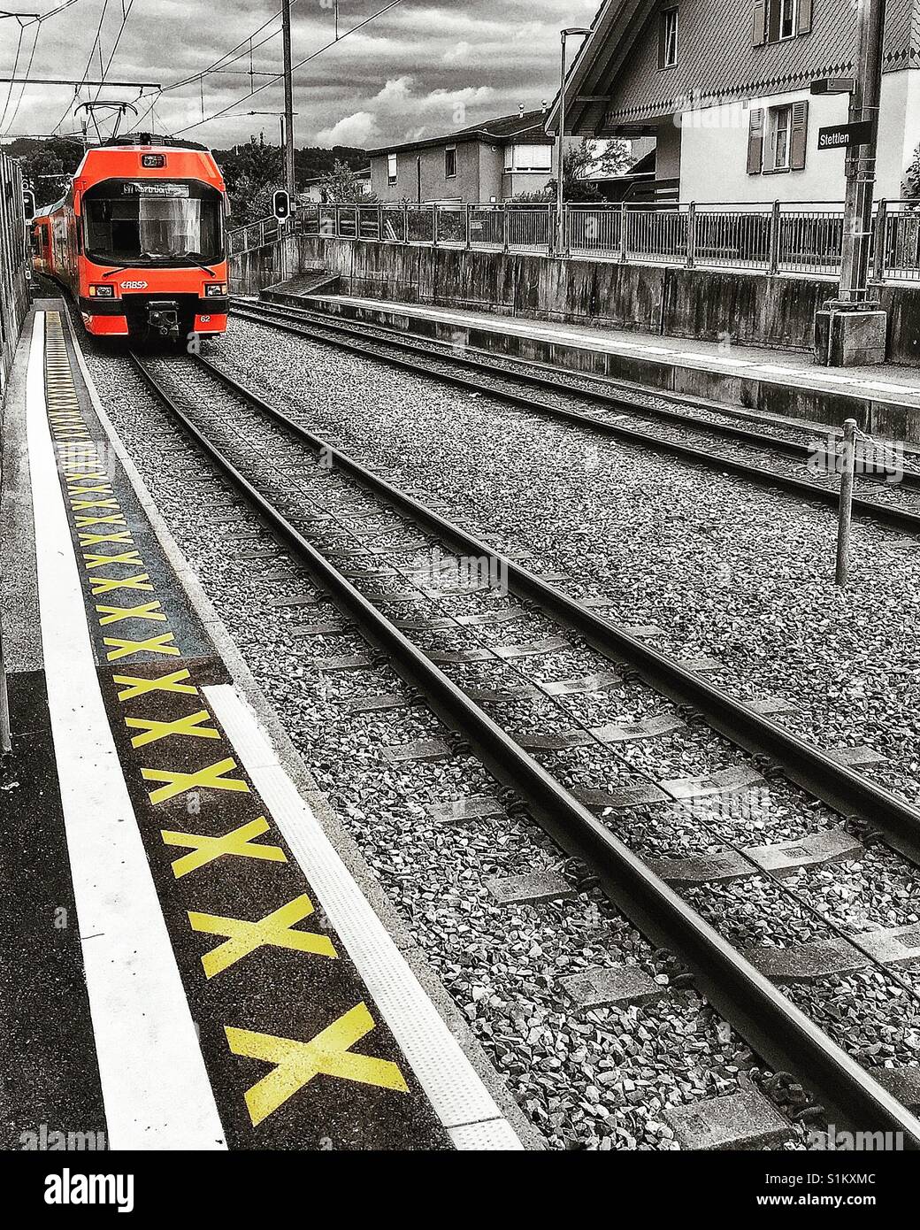 Swiss local train pulling into Stettlen station near Berne - Smartphone Captured Stock Image